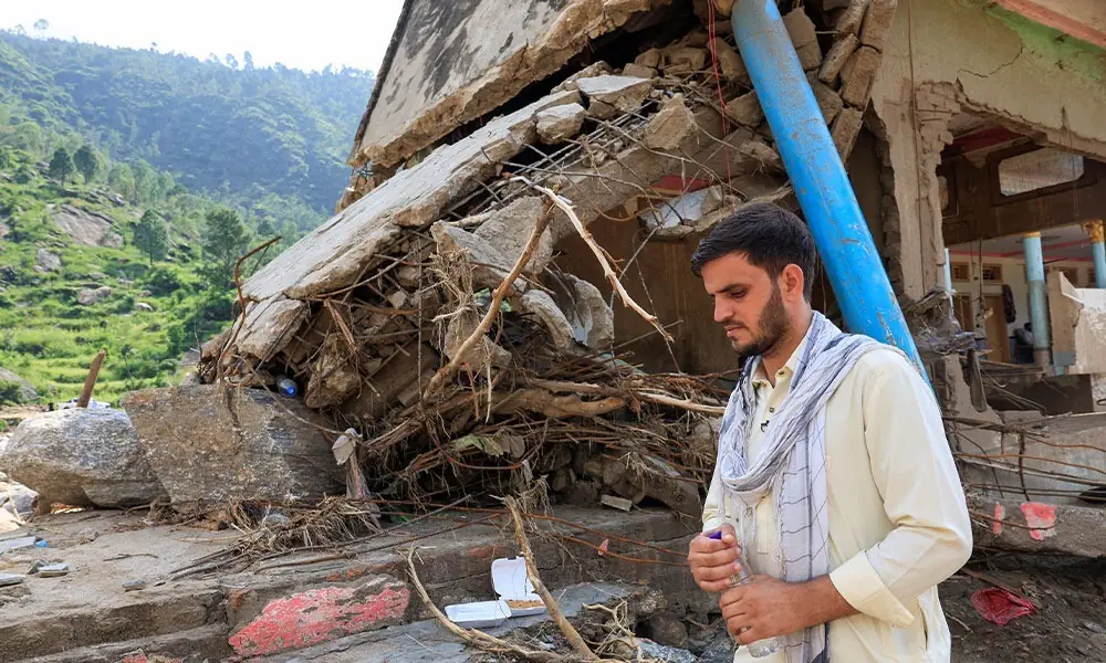  Noor Muhammad, 25, who lost 24 family members and relatives stands by the rubble of his 36-room house which was hit by devastating floods in the mountainous Qadir Nagar village of Buner district, Khyber Pakhtunkhwa province, Pakistan, August 21, 2025. REUTERS/Akhtar Soomro 