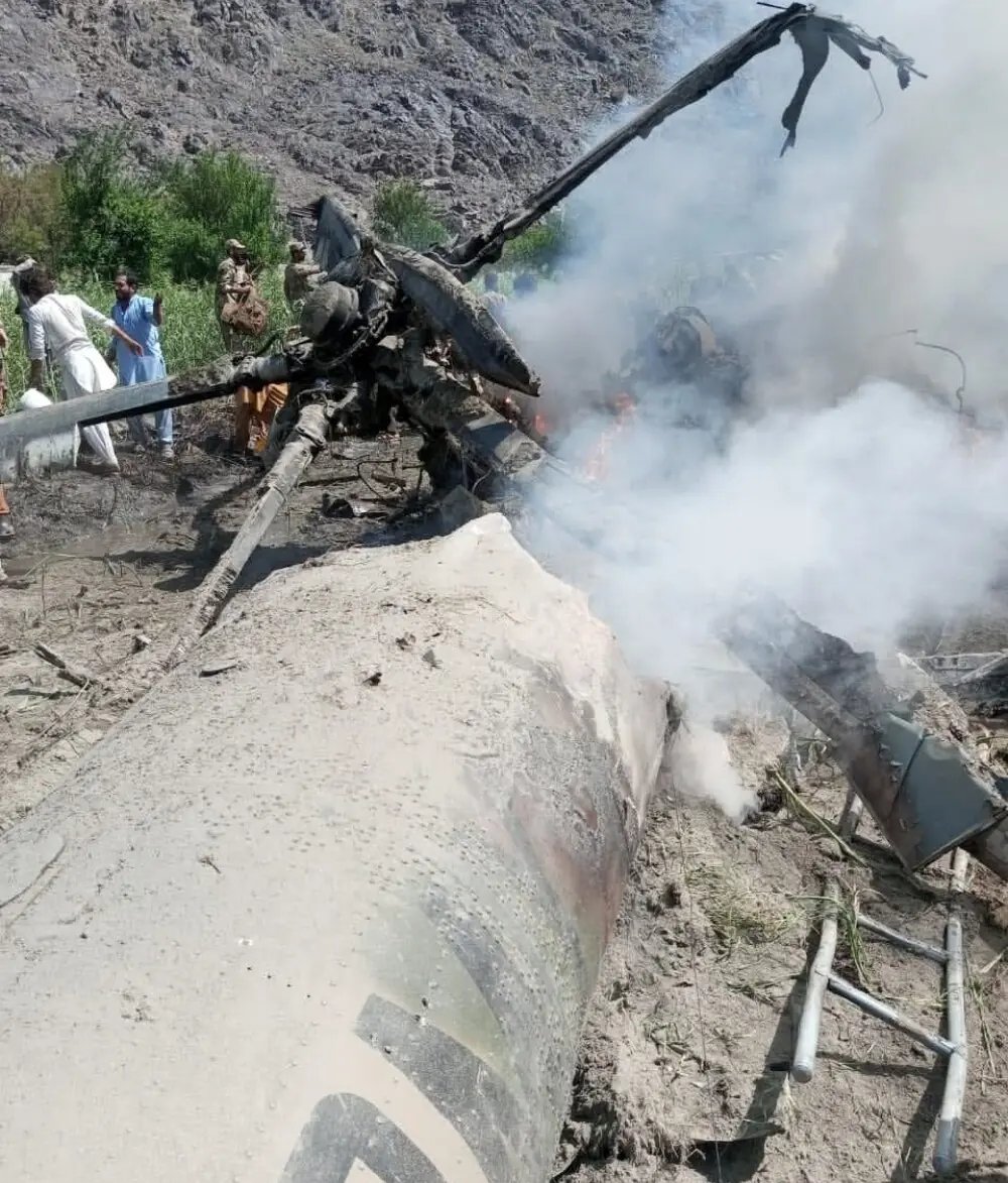   People and security personnel are trying to put out fire at the site of helicopter crash in Diamer,GB, on September 1, 2025. Photo: GB Government Spokesperson Faizullah Faraq  