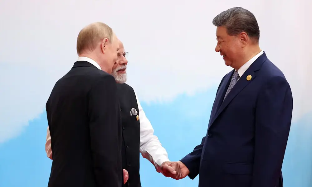 Chinese President Xi Jinping, Indian Prime Minister Narendra Modi and Russian President Vladimir Putin speak during a meeting at the Shanghai Cooperation Organisation (SCO) summit in Tianjin, China, September 1, 2025. REUTERS