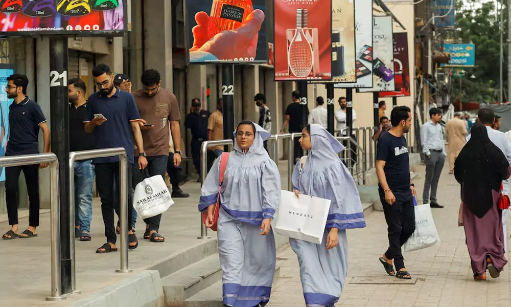 People walk outside shopping mall in Karachi, Pakistan. Photo: Reuters