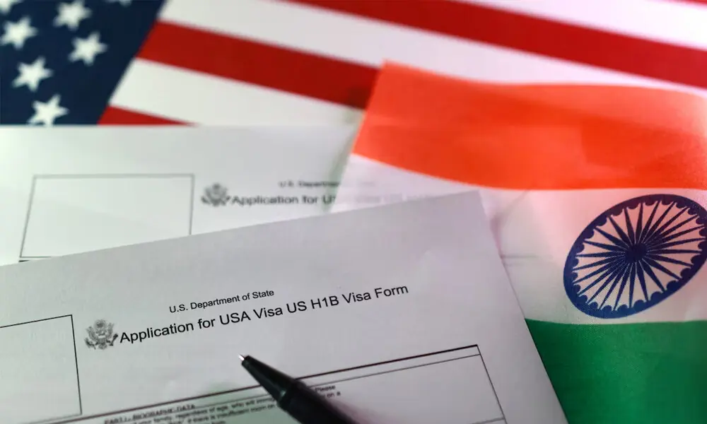 U.S. and Indian flags and U.S. H-1B Visa application forms are seen in this illustration taken, September 22, 2025. REUTERS