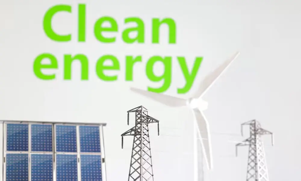 Miniatures of windmill, solar panel and electric pole are seen in front of words Clean energy in this illustration taken January 17, 2023. File Photo: Reuters