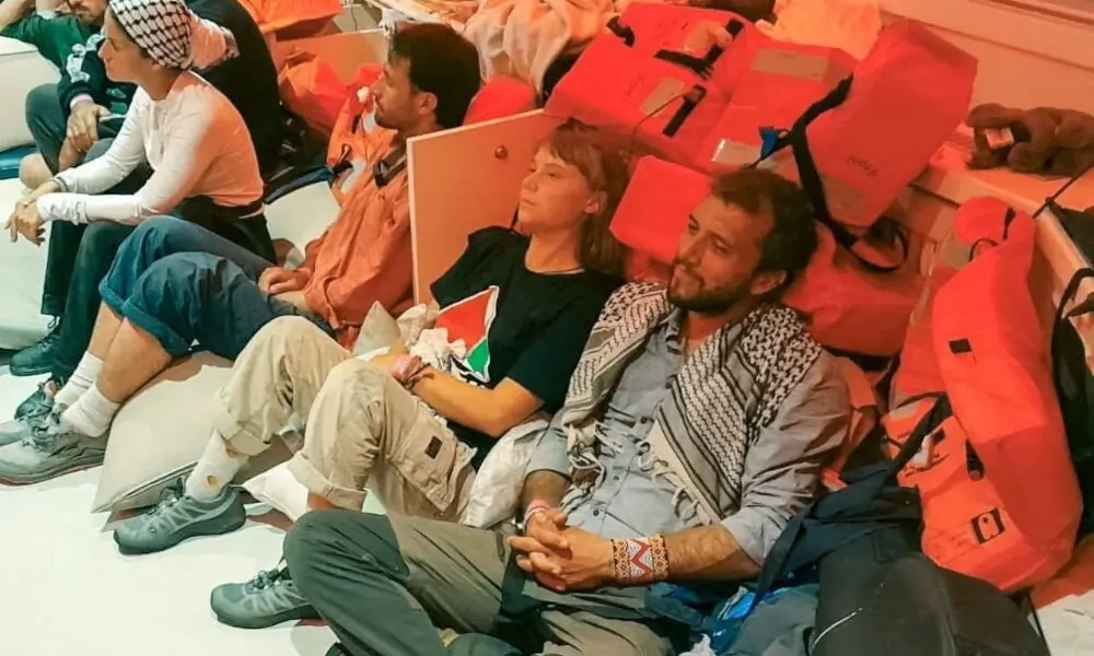 Swedish activist Greta Thunberg and Brazilian activist Thiago Avila sit in a vessel making their way to Israel, after Israel intercepted some of the vessels of the Global Sumud Flotilla aiming to reach Gaza and break Israel&rsquo;s naval blockade, in this handout image released on October 2, 2025. Photo: Reuters