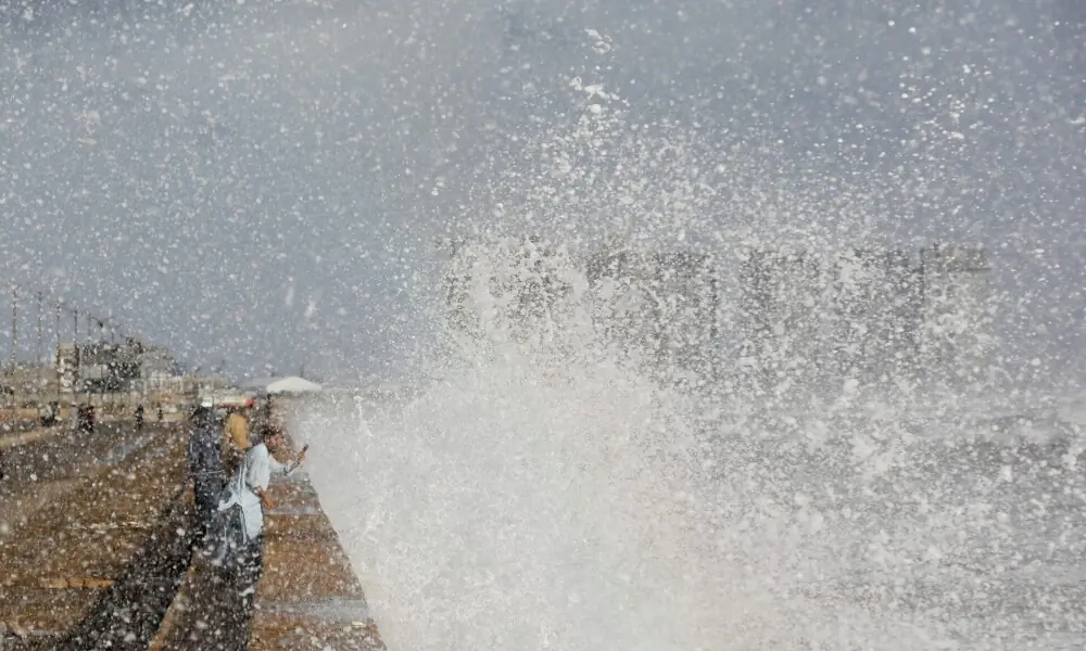 A man with a mobile phone takes a picture of rising waves before the arrival of the cyclonic storm Biparjoy over the Arabian Sea, at Clifton Beach in Karachi on June 14. Photo: Reuters