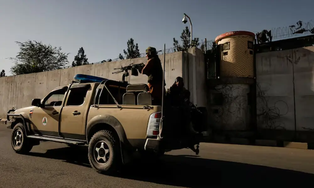 Taliban fighters ride on the back of a pickup truck as they patrol along a road in Kabul, Afghanistan October 23, 2021. File Photo: Reuters
