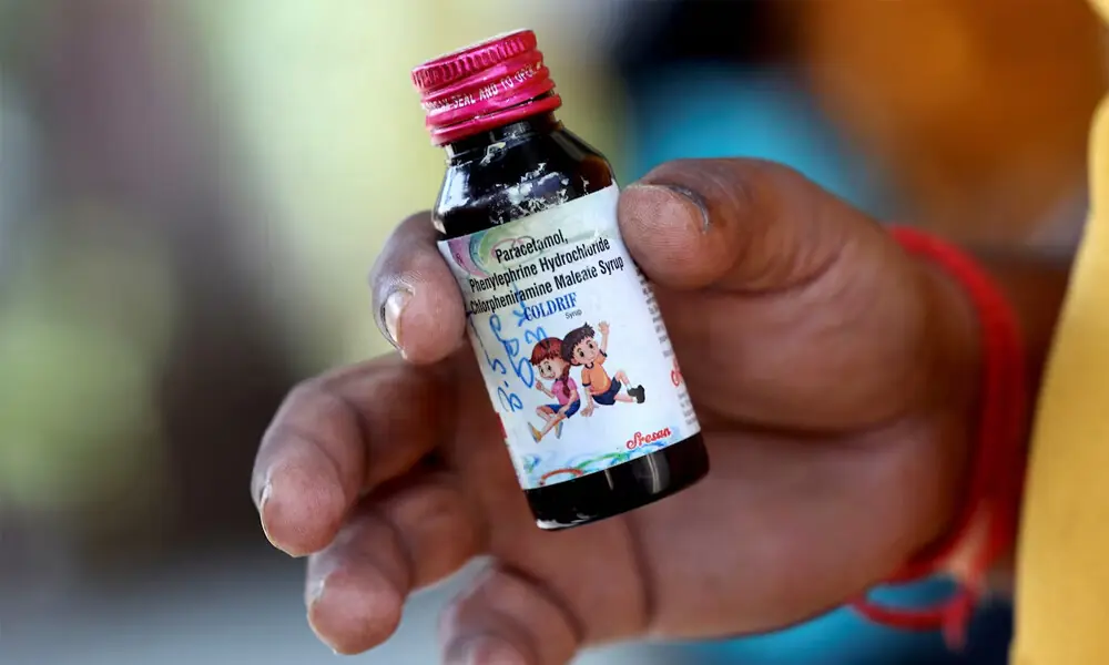 Nilesh Suryavanshi, 32, the father of a 3 year old child who has been admitted at the Government Medical College, holds a bottle of Coldrif cough syrup, which has been linked to the deaths of 17 children, in Nagpur, India, October 8, 2025. REUTERS