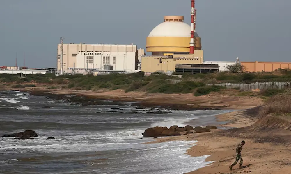 A policeman walks on a beach near Kudankulam nuclear power project in the southern Indian state of Tamil Nadu September 13, 2012. File Photo: Reuters