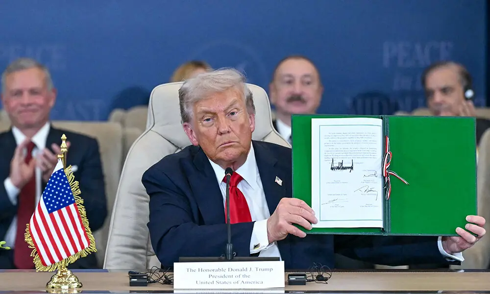 US President Donald Trump shows a signed document during a summit on Gaza in Sharm el-Sheikh on October 13, 2025. Photo: AFP