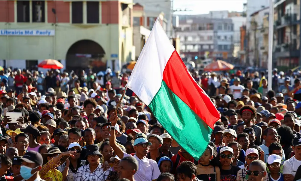A protester waves his country&rsquo;s flag as demonstrators gather outside the town hall on Independence Avenue during a nationwide youth-led protest over frequent power outages and water shortages, in Antananarivo, Madagascar, October 13, 2025. Photo: Reuters