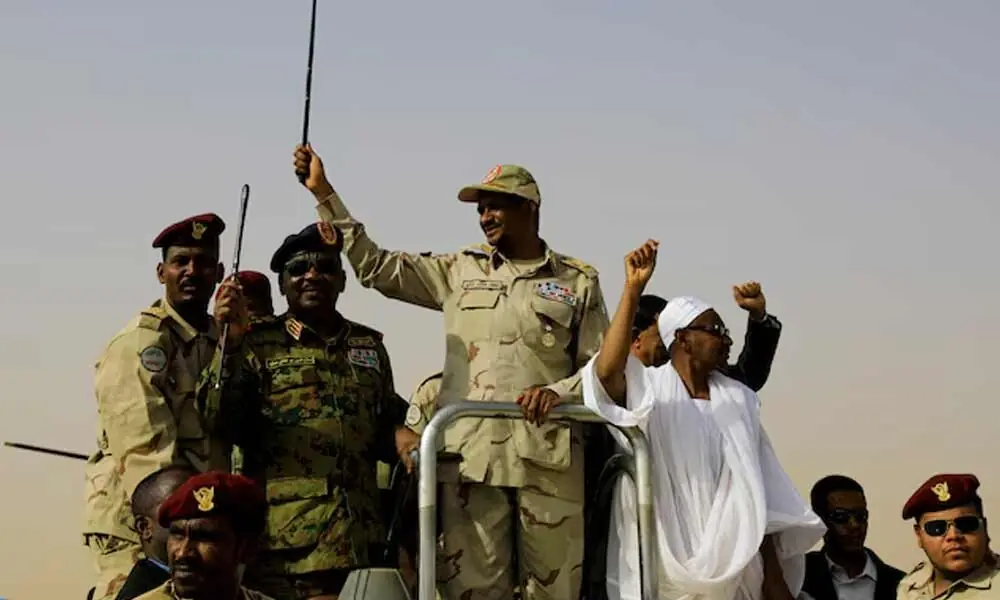 Lieutenant General Mohamed Hamdan Dagalo, deputy head of the military council and head of paramilitary Rapid Support Forces (RSF), greets his supporters as he arrives at a meeting in Aprag village, 60 kilometers away from Khartoum, Sudan, June 22, 2019. REUTERS