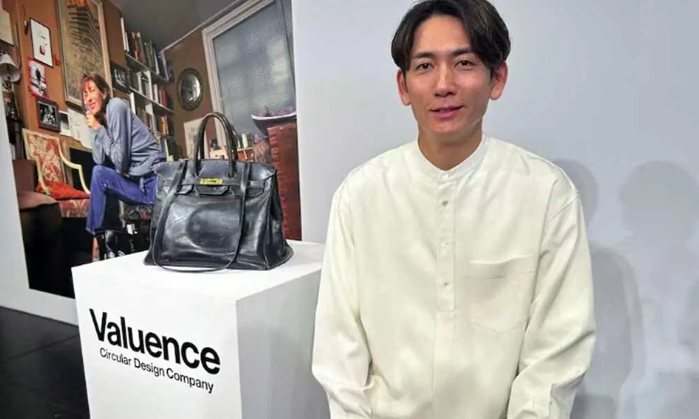 Shinsuke Sakimoto, CEO of Valuence Japan, poses for a photograph next to the Original Birkin, the original bag custom-made for late actress Jane Birkin, which the Japanese company purchased for a record 8.6 million euros ($10.04 million) at a Sotheby&rsquo;s auction in Paris earlier this year, during an unveiling event in Tokyo, Japan, November 12, 2025.