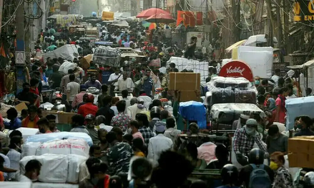 People walk at a crowded market in the old quarters of Delhi, India. Photo: Reuters