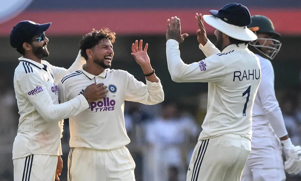 India&rsquo;s Kuldeep Yadav (C) celebrates with teammates after taking the wicket of South Africa&rsquo;s Wiaan Mulder during the first day of the second Test cricket match between India and South Africa at the Barsapara Cricket Stadium in Guwahati on November 22, 2025.