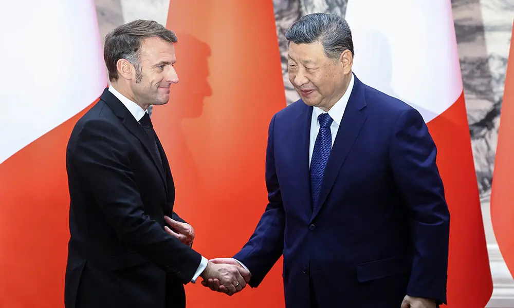 China&rsquo;s President Xi Jinping (R) and France&rsquo;s President Emmanuel Macron shake hands following a signing ceremony for agreements at the Great Hall of the People in Beijing on December 4, 2025. Photo: AFP