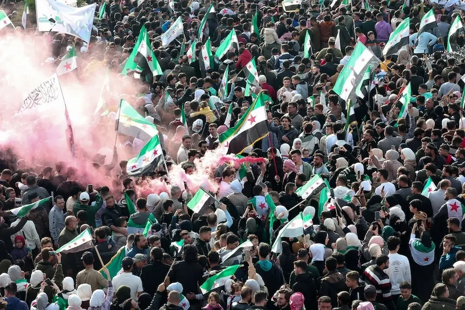 Residents of Hama gather during a protest to mark the first anniversary of the fall of Bashar al-Assad&rsquo;s regime, in Hama, Syria. Photo: Reuters