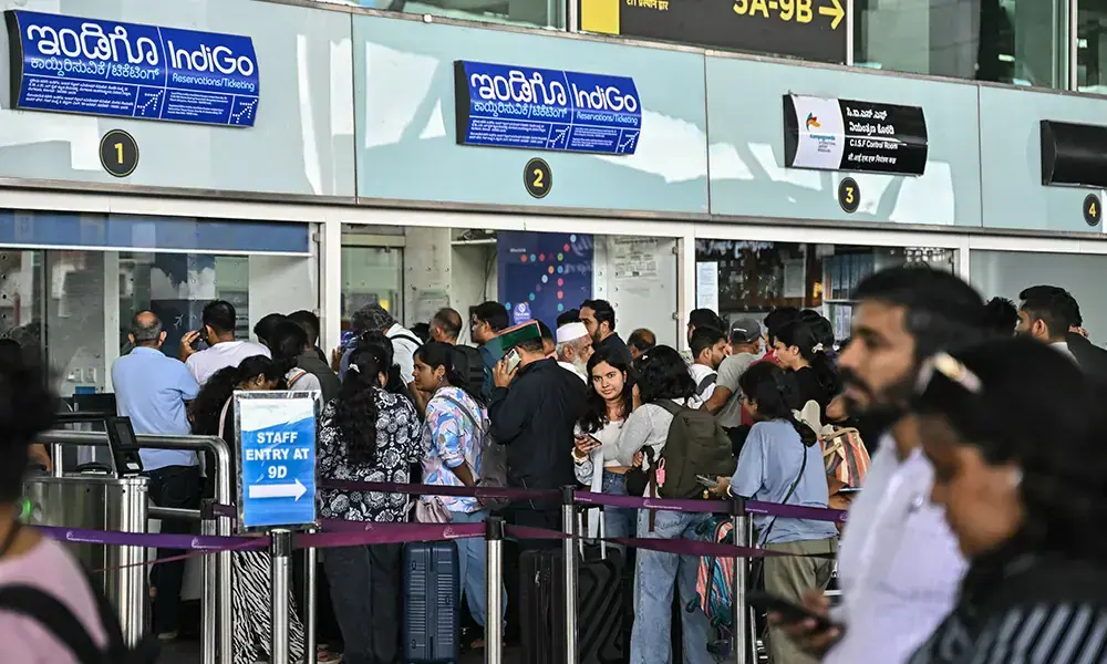 Passengers line up at an Indigo Airlines kiosk at the Kempegowda International Airport in Bengaluru on December 4, 2025. File Photo: AFP