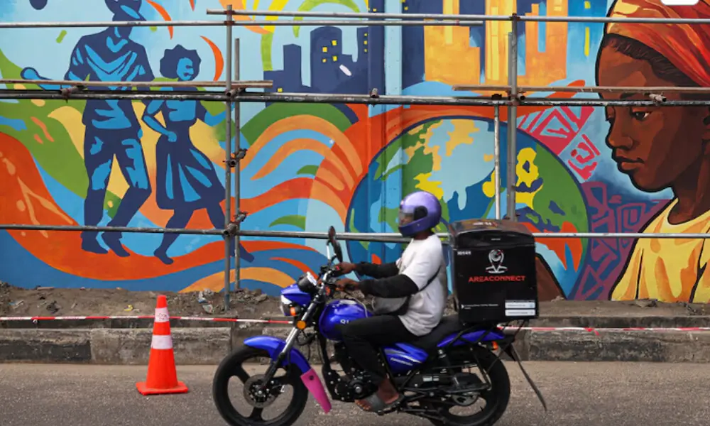 A motorcyclist drives past a mural on Ozumba Mbadiwe Way during the Lagos Street Art Festival in Victoria Island, Lagos, Nigeria, December 10, 2025. REUTERS