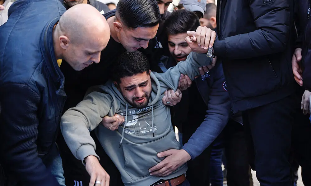 A relative reacts as he mourns over the bodies of members of the Al-Nader family, who were reportedly killed the previous day in an Israeli shelling on a school-turned-shelter in the Tuffah neighbourhood of Gaza City, ahead of their funeral on December 20, 2025. Photo: AFP