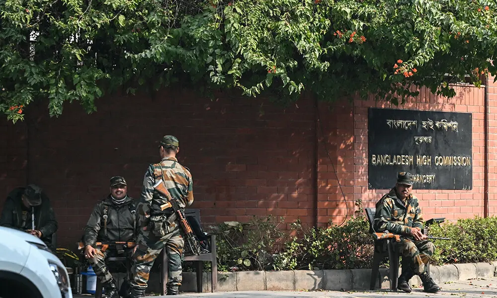 Security personnel stand guard outside the Bangladesh High Commission as right-wing activists participate in a protest march in New Delhi on December 23, 2025. Photo: AFP