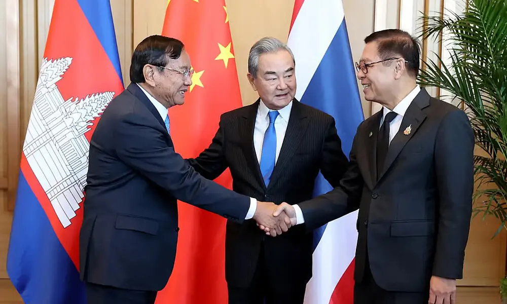 China&rsquo;s foreign minister Wang Yi (centre) looking as Cambodian foreign minister Prak Sokhonn (left) shakes hands with Thai foreign minister Sihasak Phuangketkeow. AFP