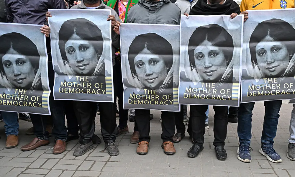 Supporters of Bangladesh&rsquo;s former prime minister Khaleda Zia hold posters with her portrait as they mourn her death outside the Evercare hospital in Dhaka on December 30, 2025. Photo: AFP
