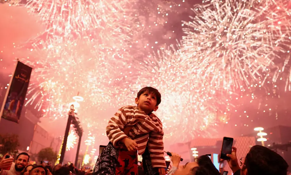 A child looks up as fireworks explode during New Year&rsquo;s celebrations in Lusail, Qatar. Photo: Reuters