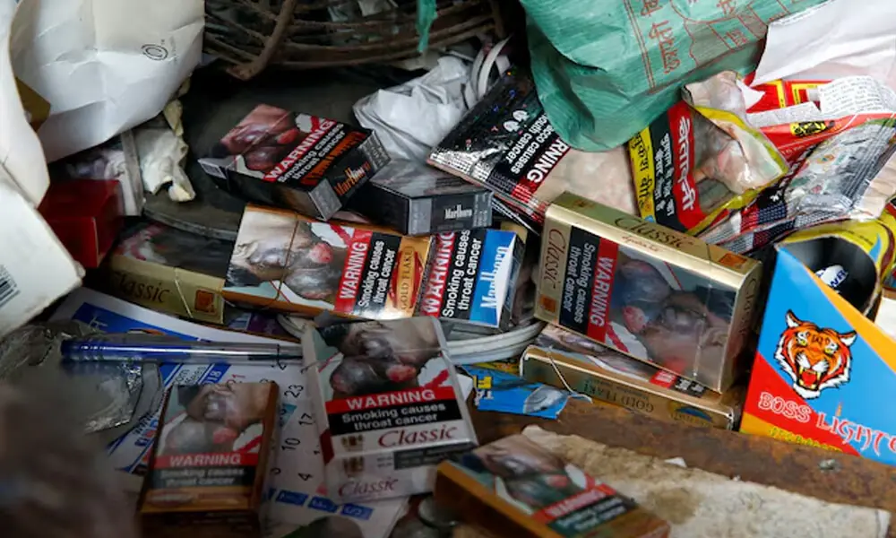 Cigarette packets with graphic pictorial warnings are pictured on the counter of a cigarette seller in Mumbai, India, January 8, 2018. REUTERS