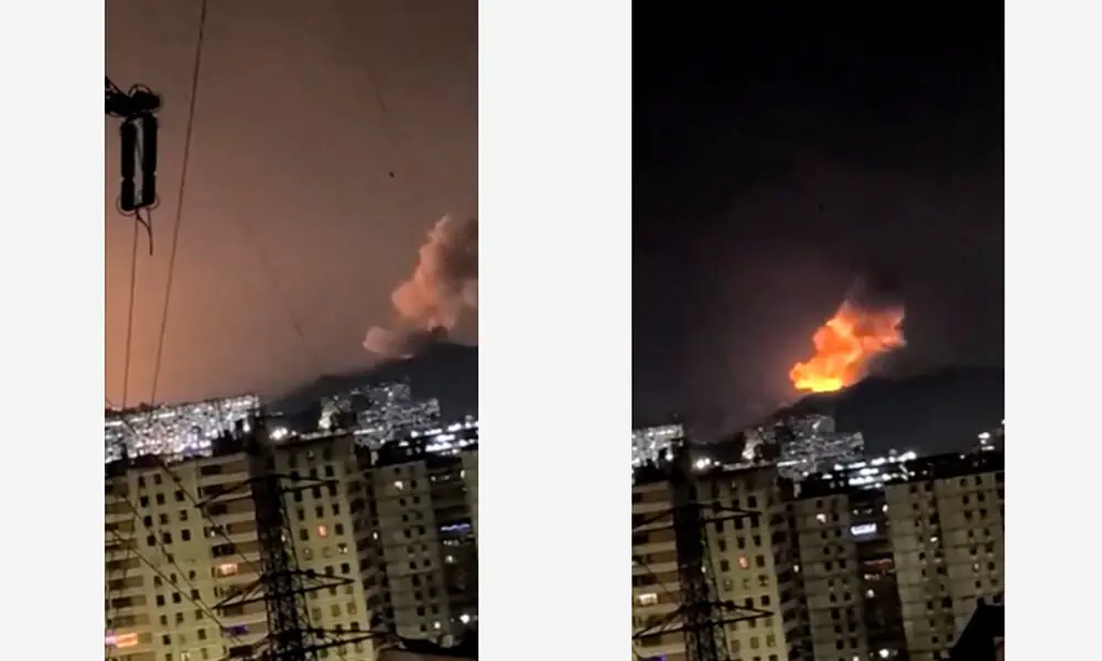 A column of smoke rises during multiple explosions in the early hours of the morning, in Caracas, Venezuela, January 3, 2026 in this screen grab obtained from video obtained by Reuters