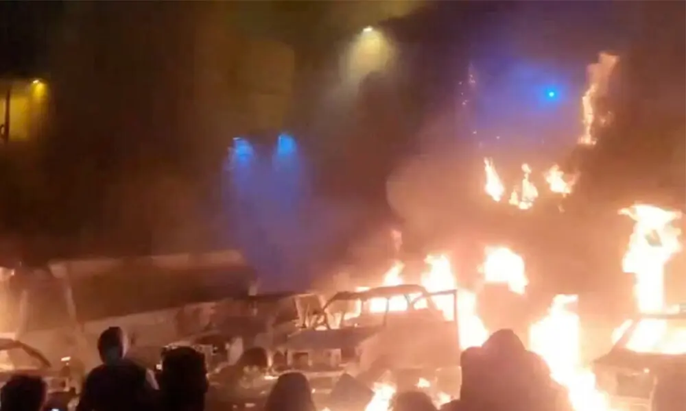 Protesters gather as vehicles burn, amid evolving anti-government unrest, in Tehran, Iran, in this screen grab obtained from a social media video released on January 9, 2026. Social Media/via REUTERS