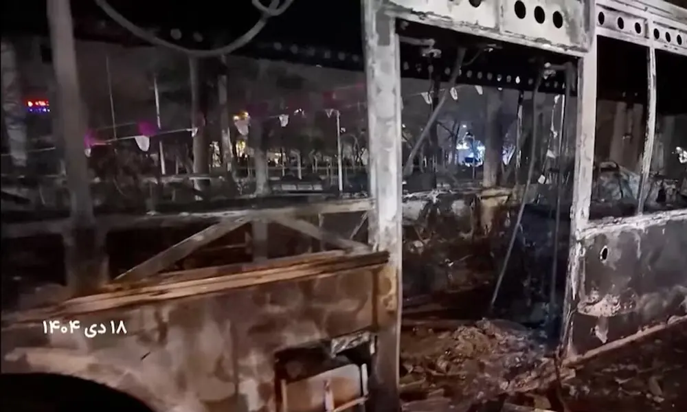  A burnt bus lies on the road following unrest sparked by dire economic conditions, in a place given as Tehran, Iran. Photo: Reuters 