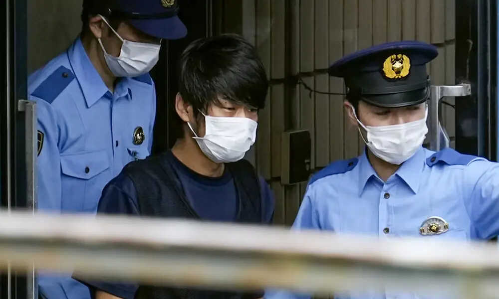Tetsuya Yamagami, Suspected of killing former Japanese premier Shinzo Abe, is escorted by police officers as he is taken to prosecutors, at Nara-nishi police station in Nara, western Japan. Photo: Reuters