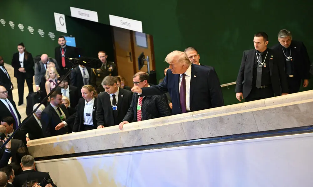 US President Donald Trump (C) rises his fist to the press after the &ldquo;Board of Peace&rdquo; meeting during the World Economic Forum (WEF) annual meeting in Davos on January 22, 2026. AFP