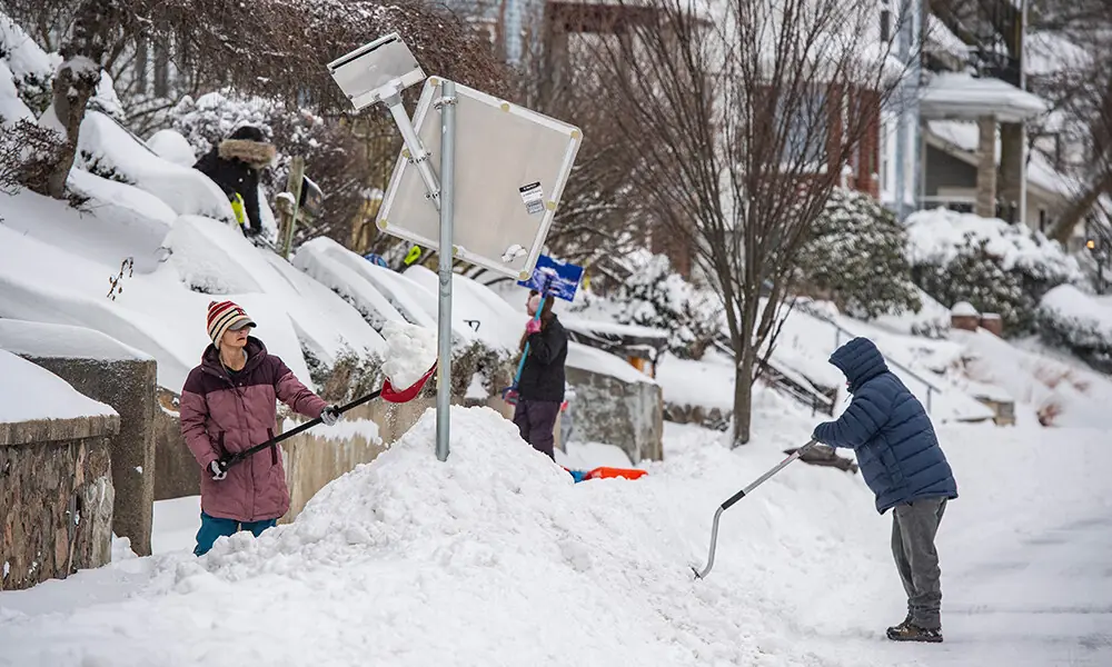 People shovel snow outside their homes in Winthrop, Massachusetts on January 26, 2026. Photo: AFP
