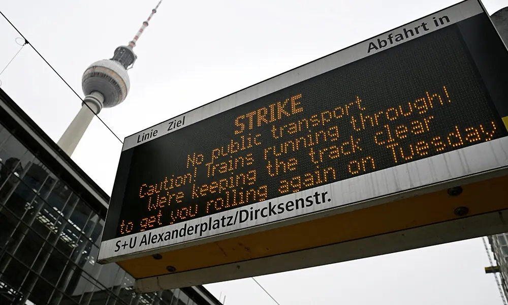 A sign announcing a general strike in public transports is seen next to landmark TV tower at Berlin&rsquo;s Alexanderplatz station on February 2, 2026, as unions called for a nationwide strike in a dispute over pay and conditions. Photo: AFP