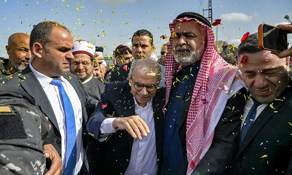 This handout picture released by the Lebanese Government Press Office shows Lebanon&rsquo;s Prime Minister Nawaf Salam being showered with confetti as he is received by locals during a tour in the heavily-damaged southern village of Dhayra near the border with Israel on February 7, 2026. Photo: AFP