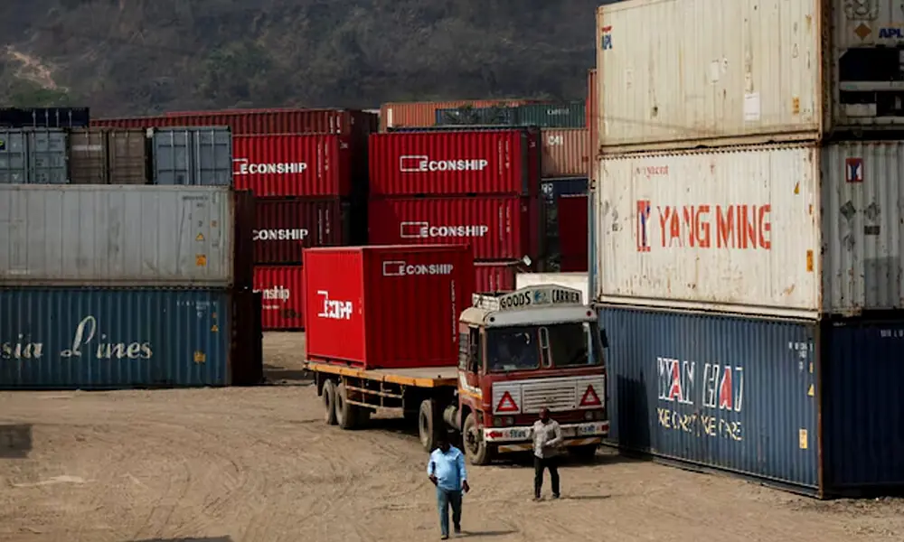 Men walk inside a shipping container warehouse in Navi Mumbai, India, February 4, 2026. REUTERS