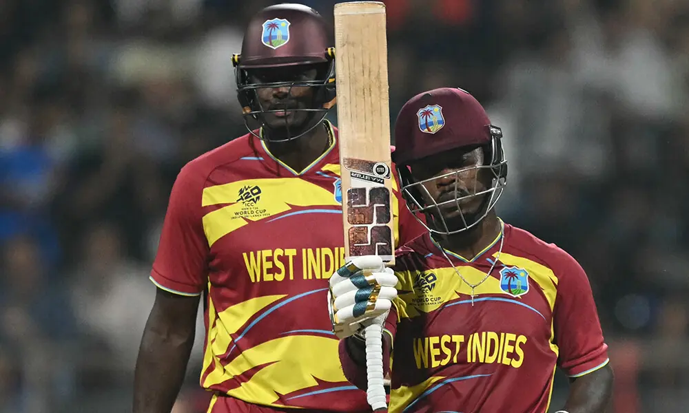 West Indies&rsquo; Sherfane Rutherford (R) celebrates after scoring a half-century (50 runs) during the 2026 ICC Men&rsquo;s T20 Cricket World Cup group stage match between England and West Indies at the Wankhede Stadium in Mumbai on February 11, 2026.  Photo: AFP