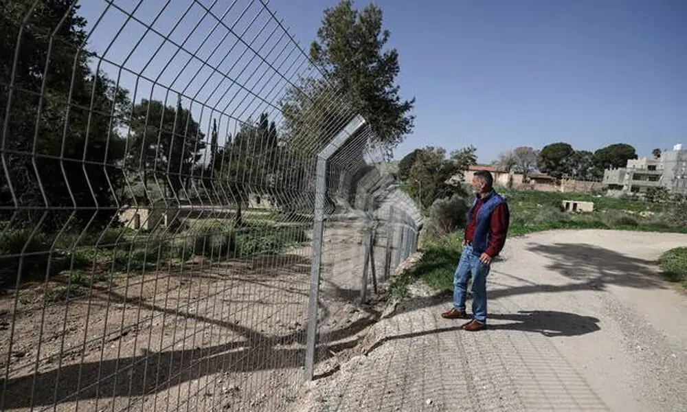 Palestinian Ameed Dusouki, a member of the Burqa village council, stands at a fence installed by Jewish settlers after they announced their control over the historical Al-Masoudiya Ottoman era train station, which operated between the Palestinian cities of Nablus and Tulkarm in the 1920s, just north of the city of Nablus, in the northern Israeli-occupied West Bank on February 15, 2026. Photo: AFP