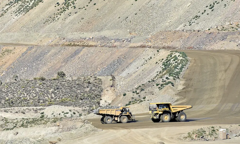 Heavy mining equipment haul overburden material across Molycorp&rsquo;s Mountain Pass Rare Earth facility in Mountain Pass, California June 29, 2015. The vehicles are able to carry up to 100 tons of rock. File Photo: Reuters