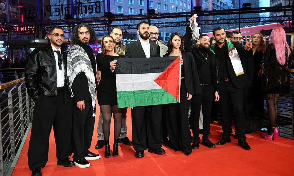 Palestinian director Abdallah Alkhatib (2nd L, also spelled Abdallah Al-Khatib) and the crew of the film &ldquo;Chronicles From the Siege&rdquo; hold a Palestinian flag as they arrive on the red carpet for the Award Ceremony of the 76th Berlinale, Europe&rsquo;s first major film festival of the year, in Berlin on February 21, 2026. Photo: AFP