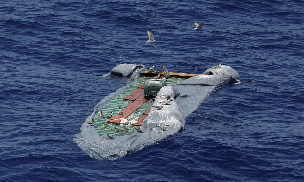 Birds rest at the remains of a rubber boat, as seen from the migrant search and rescue ship Sea-Watch 5, operated by German NGO Sea-Watch, in the search and rescue (SAR) zone in the central Mediterranean off Libya, August 9, 2025. File Photo: Reuters