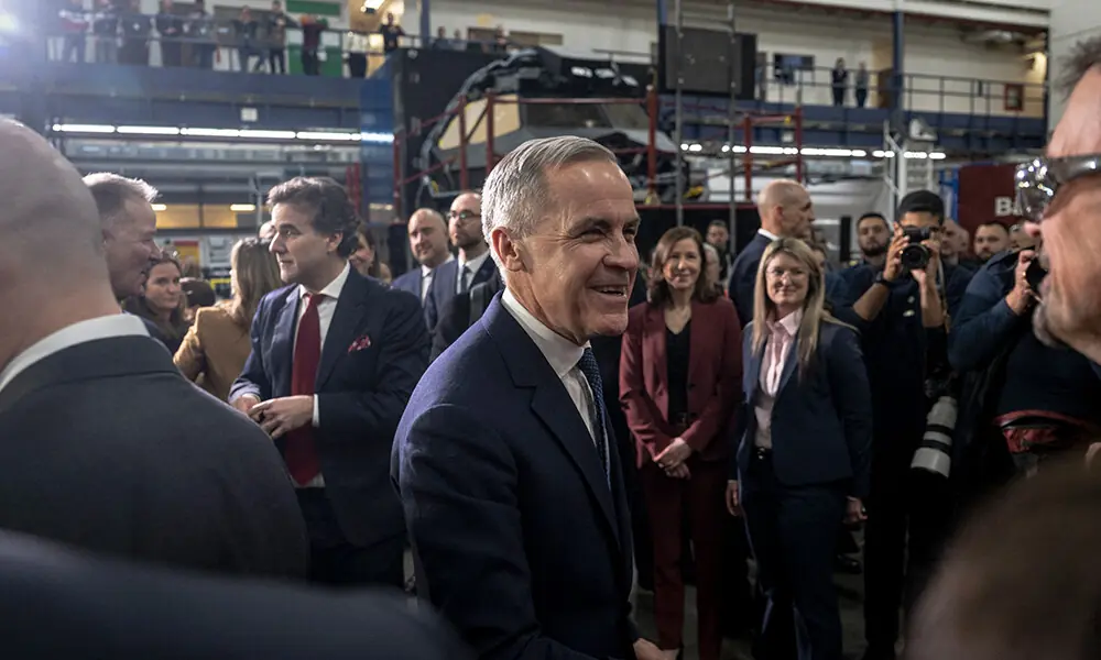 Canadian Prime Minister Mark Carney greets people after making an announcement on new measures to strengthen security, create prosperity, and reinforce strategic autonomy at Canadian Aviation Electronics (CAE), a flight simulation company, in Montreal, Quebec, Canada, on February 17, 2026. File Photo: AFP