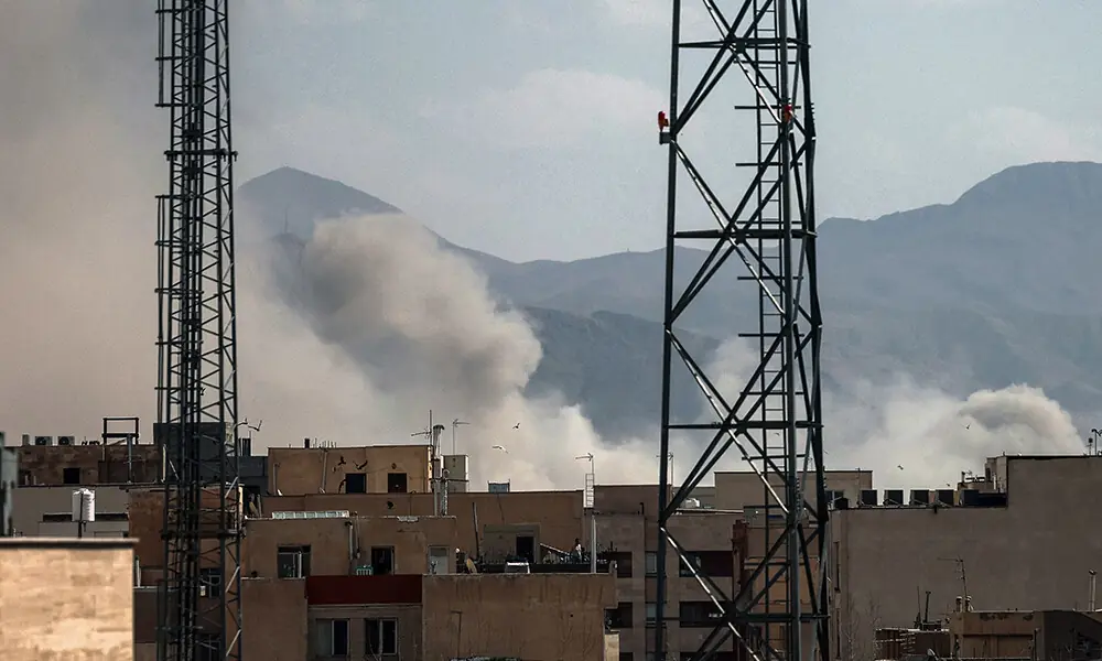 A plume of smoke rises following a reported explosion in Tehran on February 28, 2026. Photo: AFP