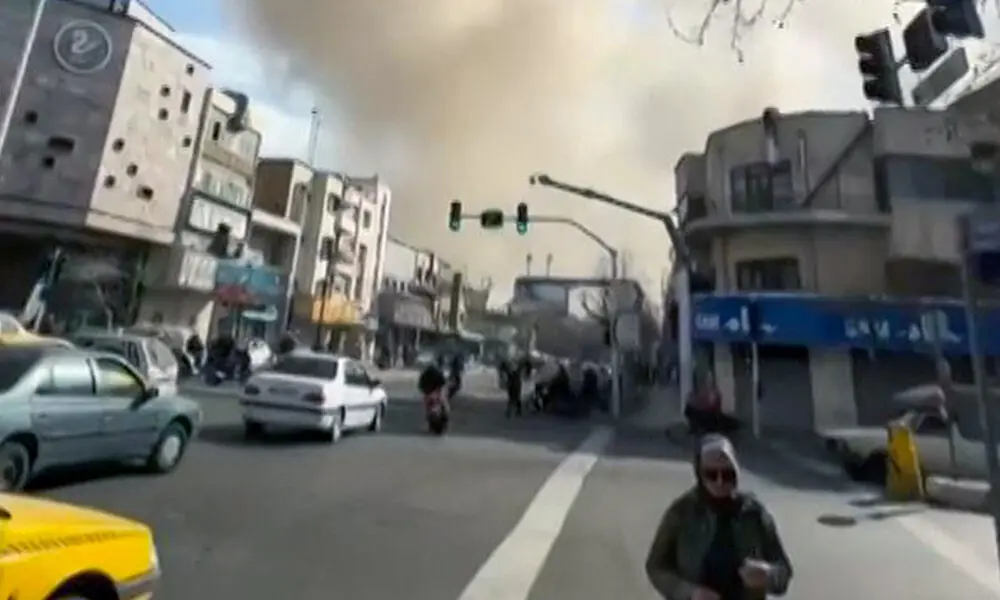 This video grab taken from UGC images posted on social media on February 28, 2026, and verified by AFPTV teams in Paris, shows a person walking as a plume of smoke rises following a reported explosion in Tehran. Photo: AFP This video grab taken from UGC images posted on social media on February 28, 2026, and verified by AFPTV teams in Paris, shows a person walking as a plume of smoke rises following a reported explosion in Tehran. Photo: AFP