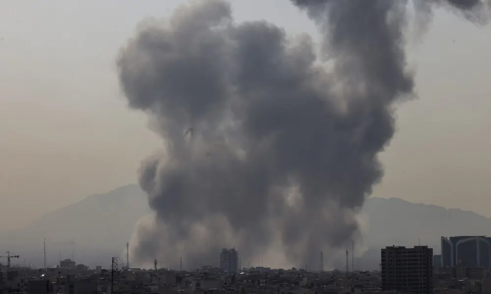 A plume of smoke rises following a reported explosion in Tehran on February 28, 2026. Photo: AFP