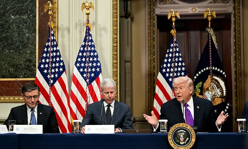 US Speaker of the House Mike Johnson (L) and US Secretary of Energy Chris Wright (C) listen to US President Donald Trump speak during a roundtable on Ratepayer Protection Pledge in the Indian Treaty Room at the Eisenhower Executive Office Building on the White House campus in Washington, DC on March 4, 2026. Photo: AFP