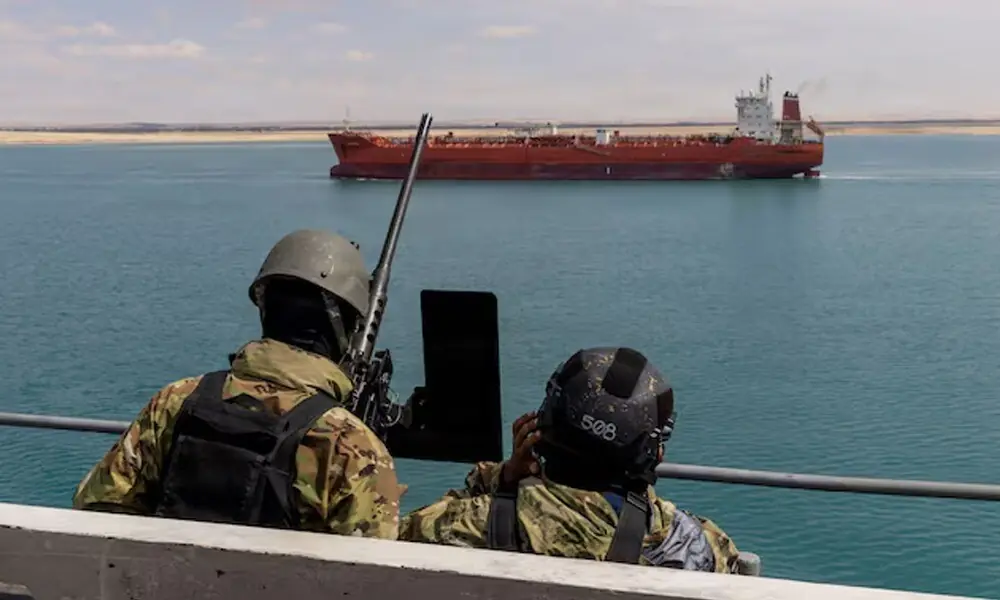U.S. Navy sailors stand small craft action team watch on a catwalk of the aircraft carrier USS Gerald R. Ford as it transits the Suez Canal, en route to support the Operation Epic Fury attack on Iran, in Egypt March 5, 2026. U.S. Navy/Handout via REUTERS