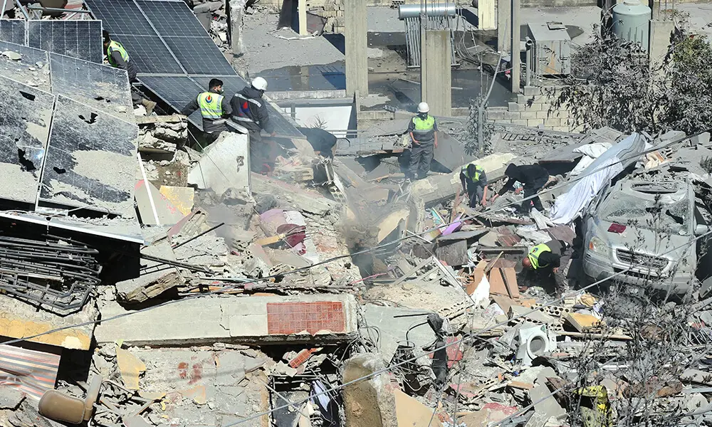 First aid responders inspect the site of an Israeli airstrike that targeted a neighborhood in the southern Lebanese village of Ghaziyeh on March 8, 2026. Photo: AFP First aid responders inspect the site of an Israeli airstrike that targeted a neighborhood in the southern Lebanese village of Ghaziyeh on March 8, 2026. Photo: AFP