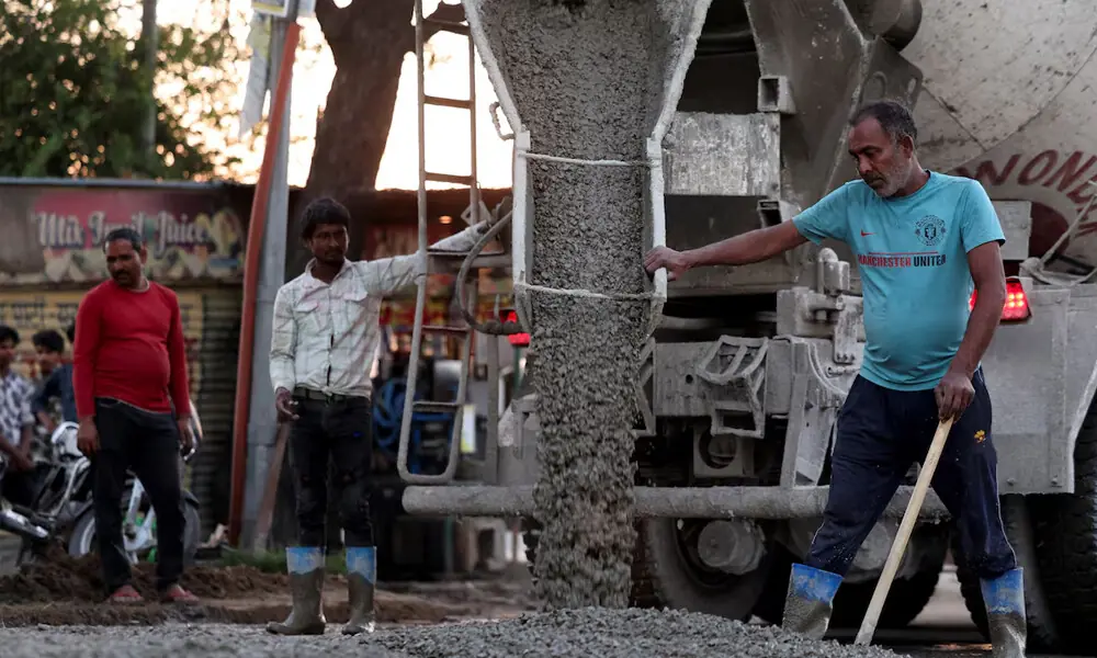 Workers unload a mixture of cement and gravel while constructing a road in New Delhi, India, March 3, 2026. Photo: Reuters Workers unload a mixture of cement and gravel while constructing a road in New Delhi, India, March 3, 2026. Photo: Reuters