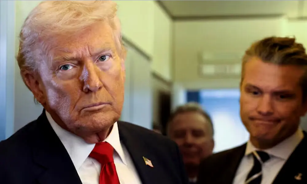 U.S. President Donald Trump, with Secretary of Defense Pete Hegseth at his side, looks on as he speaks to reporters aboard Air Force One on a flight from Dover, Delaware, to Miami, Florida, U.S. REUTERS